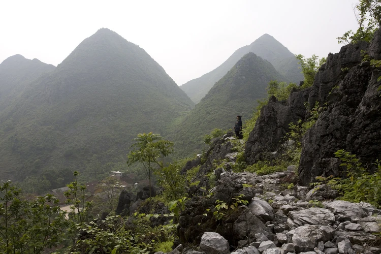 Zhuang lady overlooking mountain view